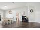 Bright dining area with wood floors, modern lighting, and access to the kitchen at 37113 Waldo Dr, Dade City, FL 33525