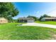 Charming single-story home featuring a well-manicured lawn, long driveway, attached garage, and basketball hoop at 37113 Waldo Dr, Dade City, FL 33525