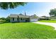 Well-maintained single-story home with fresh landscaping and an American flag, located on a lush green lawn at 37113 Waldo Dr, Dade City, FL 33525