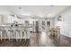 Open-concept kitchen featuring white cabinetry, stainless steel appliances, and adjacent dining area at 37113 Waldo Dr, Dade City, FL 33525