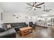 Stylish living room featuring vaulted ceilings, dark wood floors, and a view of the modern, open-concept kitchen at 37113 Waldo Dr, Dade City, FL 33525