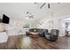 Cozy living room featuring rich wood floors, comfortable seating, and plenty of natural light at 37113 Waldo Dr, Dade City, FL 33525