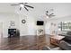 Spacious living room featuring dark wood floors, bright lighting, and multiple doorways at 37113 Waldo Dr, Dade City, FL 33525