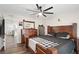 Comfortable main bedroom featuring a wooden bed frame, ceiling fan, and wood-look flooring at 37113 Waldo Dr, Dade City, FL 33525