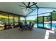 Screened-in patio with view of the pool, playground, and lush green yard at 37113 Waldo Dr, Dade City, FL 33525