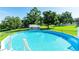 Backyard pool with ladder and fenced in area at 37113 Waldo Dr, Dade City, FL 33525