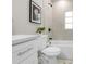 Bright bathroom featuring a white vanity, quartz countertop, tiled shower/tub, and modern fixtures at 3907 W Walnut St, Tampa, FL 33607