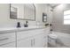 Bathroom featuring a modern sink, white cabinets, quartz countertop, and a large framed mirror at 3907 W Walnut St, Tampa, FL 33607