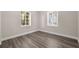 Well lit bedroom with wood-look floors, light walls, and two windows at 3907 W Walnut St, Tampa, FL 33607