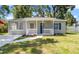 Charming single-story home with a cozy front porch, fresh landscaping, and a well-maintained lawn at 3907 W Walnut St, Tampa, FL 33607