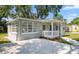 Attractive home featuring a stone driveway, a welcoming front porch, and manicured greenery at 3907 W Walnut St, Tampa, FL 33607