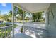 Inviting covered front porch with decorative railing that provides a view of the quiet neighborhood street at 3907 W Walnut St, Tampa, FL 33607