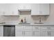Kitchen featuring stainless steel dishwasher, granite countertops and stylish white cabinets at 3907 W Walnut St, Tampa, FL 33607