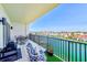 Relaxing balcony featuring views of the harbor and waterway, with a comfortable chair and a grill at 400 150Th Ave # 504, Madeira Beach, FL 33708