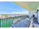 Relaxing balcony featuring views of the harbor, with a table and seating for outdoor enjoyment at 400 150Th Ave # 504, Madeira Beach, FL 33708