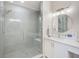 Modern bathroom featuring a glass-enclosed shower, quartz countertops, and sleek fixtures at 400 150Th Ave # 504, Madeira Beach, FL 33708
