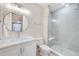 Modern bathroom with a glass shower, white vanity, and neutral gray tones at 400 150Th Ave # 504, Madeira Beach, FL 33708