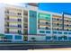 Exterior view of modern apartments with multiple balconies and ample parking at 400 150Th Ave # 504, Madeira Beach, FL 33708