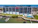 Apartment building with balconies overlooking a pool and waterway, near boat docks at 400 150Th Ave # 504, Madeira Beach, FL 33708
