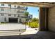 View from inside parking garage towards entrance, with well manicured landscaping at 400 150Th Ave # 504, Madeira Beach, FL 33708
