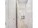 Hallway view leading to a bright bathroom featuring modern fixtures and clean design at 400 150Th Ave # 504, Madeira Beach, FL 33708