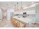 Bright kitchen features an island with bar seating, stainless appliances, and modern finishes at 400 150Th Ave # 504, Madeira Beach, FL 33708