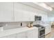 Bright kitchen features white cabinets, stainless steel appliances, and modern countertops at 400 150Th Ave # 504, Madeira Beach, FL 33708
