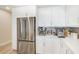 Modern kitchen features stainless steel refrigerator and white cabinetry at 400 150Th Ave # 504, Madeira Beach, FL 33708