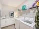 Well-equipped laundry room with modern washer and dryer units and ample storage at 400 150Th Ave # 504, Madeira Beach, FL 33708
