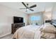 Comfortable main bedroom with wood furnishings, a ceiling fan, and balcony access at 400 150Th Ave # 504, Madeira Beach, FL 33708