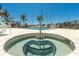 Relaxing pool and hot tub area with palm trees and lounge chairs, perfect for unwinding at 400 150Th Ave # 504, Madeira Beach, FL 33708