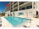 Community pool with lounge chairs, offering a relaxing and refreshing space for residents at 400 150Th Ave # 504, Madeira Beach, FL 33708