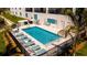 Community swimming pool with lounge chairs, providing a relaxing space for residents at 400 150Th Ave # 504, Madeira Beach, FL 33708