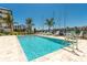 Sparkling pool surrounded by lounge chairs, perfect for relaxing near the marina and waterway at 400 150Th Ave # 504, Madeira Beach, FL 33708