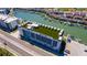 Aerial view of building rooftop with lounge area overlooking waterfront and neighborhood at 400 150Th Ave # 504, Madeira Beach, FL 33708