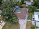 Aerial view of the property featuring a brown roof, pool with screened enclosure, and well-maintained surroundings at 4317 S Hale Ave, Tampa, FL 33611