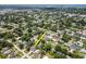 Aerial real estate shot showcases a home with a pool in a neighborhood with lush greenery near the water at 4317 S Hale Ave, Tampa, FL 33611