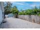 Backyard featuring gravel area, lush palm trees, and a storage shed at 4317 S Hale Ave, Tampa, FL 33611