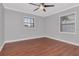 Bedroom featuring wood floors and ample natural light from the two windows at 4317 S Hale Ave, Tampa, FL 33611