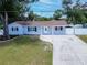 Charming single-story home featuring a well-manicured lawn, classic shutters, and a pristine driveway at 4317 S Hale Ave, Tampa, FL 33611