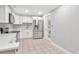 Modern kitchen featuring white cabinets, stainless steel appliances, and tile floors at 4317 S Hale Ave, Tampa, FL 33611
