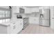 Modern kitchen featuring white cabinets, stainless steel appliances, and tile floors at 4317 S Hale Ave, Tampa, FL 33611