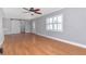 Open living room with hardwood floors and fresh gray paint shows space and updated design at 4317 S Hale Ave, Tampa, FL 33611