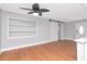 Open living room with hardwood floors and fresh gray paint shows space and updated design at 4317 S Hale Ave, Tampa, FL 33611