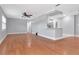 Open living room with hardwood floors and fresh gray paint shows space and updated design at 4317 S Hale Ave, Tampa, FL 33611