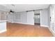 Open living room with hardwood floors and fresh gray paint shows space and updated design at 4317 S Hale Ave, Tampa, FL 33611