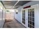 Covered patio with white door and 'Fat Boy Blvd' sign adding character to the outdoor space at 4317 S Hale Ave, Tampa, FL 33611