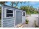 Pool shed with a corrugated metal door and access to gravel space around it at 4317 S Hale Ave, Tampa, FL 33611