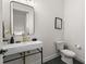 Chic powder room features a sleek, wall-mounted sink with gold fixtures and stylish decor at 4913 N Nebraska Ave # 5, Tampa, FL 33603
