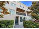 Beautiful townhouse showcasing a private balcony, stucco facade, and well-kept landscaping at 4913 N Nebraska Ave # 5, Tampa, FL 33603
